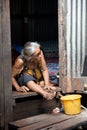 A old woman living in a slum